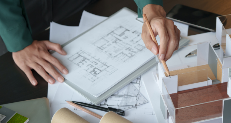 Professional engineering consultant reviewing architectural blueprints for an Abu Dhabi development project.