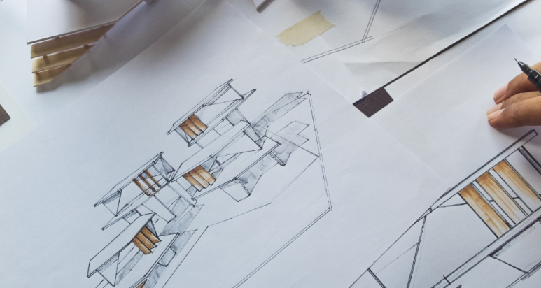 Licensed engineering consultant in Abu Dhabi office reviewing civil engineering site plans and structural blueprints.