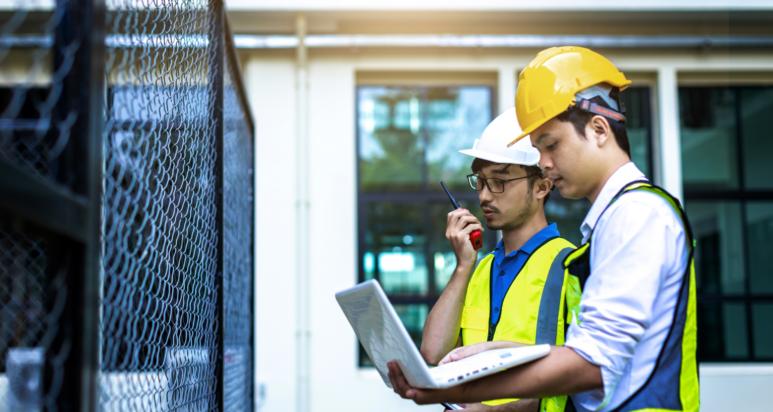 A professional engineer reviewing structural blueprints for a commercial development managed by a top engineering consultancy in Abu Dhabi.
